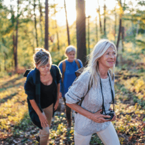Sunset Flagstaff Forest Bathing experience, three people immersed in golden forest light.