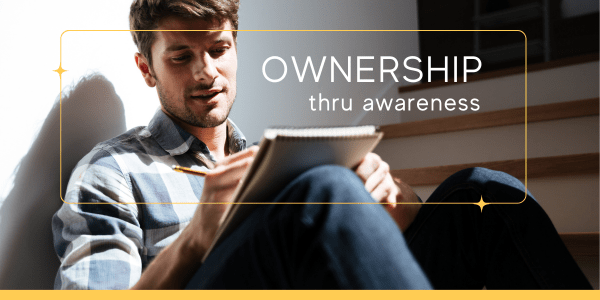 Man journaling in natural light as part of authentic living exercises for self-awareness and values clarification during the Ownership phase.