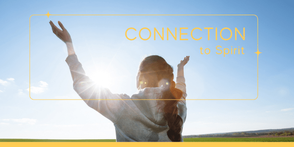 A woman with arms wide open to the sky, practicing authentic living exercises by connecting with Spirit for deeper purpose and self-awareness.