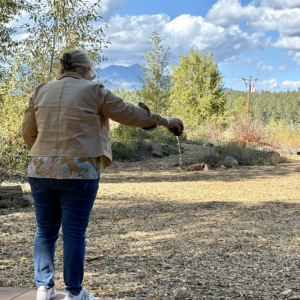 Participant offering tea to the land at a Flagstaff forest corporate team building event